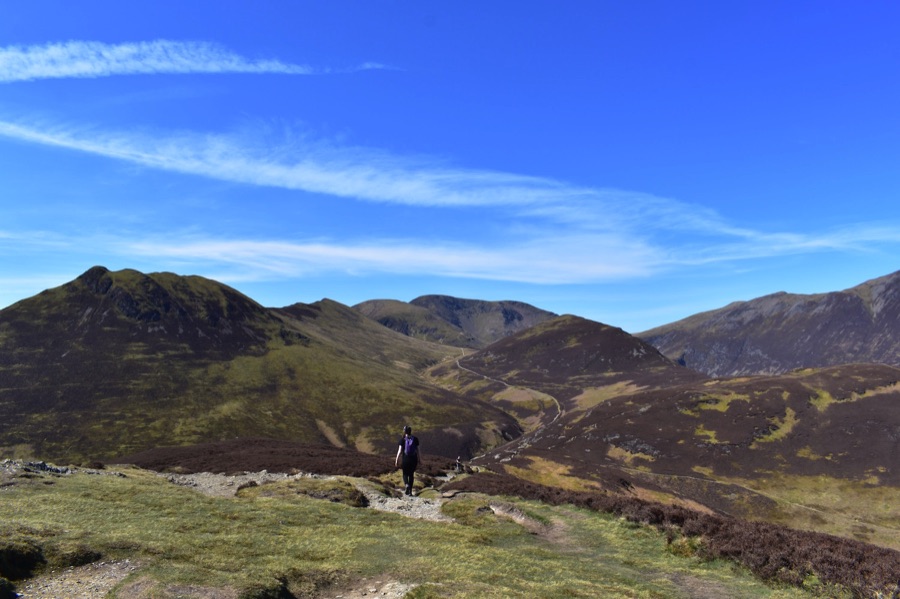 People walking along a mountain path in the Lake District